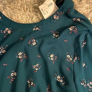 Dark green/teal blouse with floral design